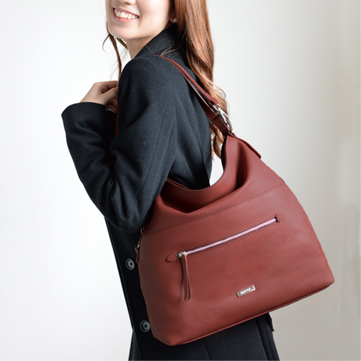 smiling japanese women carrying red leather shoulder bag